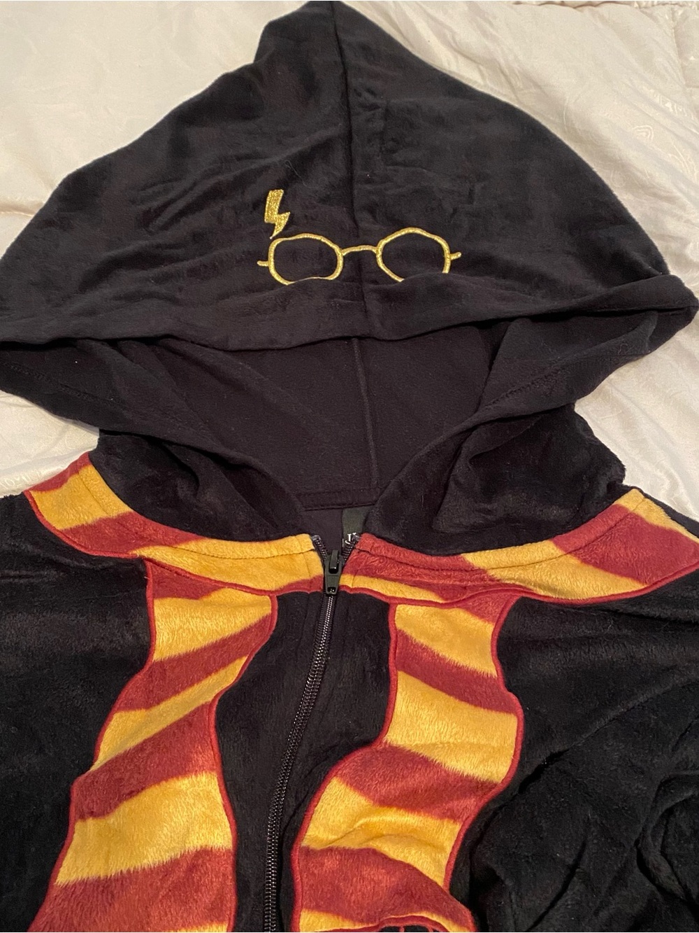 Black Hooded Jumpsuit with Gold Embroidered Glasses and Red-Gold Scarf Accent